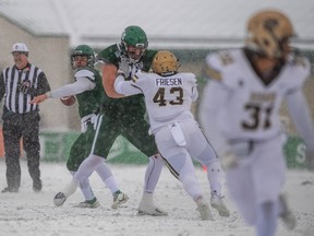 University of Saskatchewan Huskies' offensive lineman Dayton Black provides protection for quarterback Mason Nyhus during the 2022 Canada West semifinal football game against the Manitoba Bisons. (Electric Umbrella/Huskie Athletics)