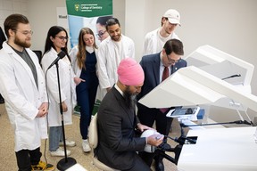 Second year dental students watch federal NDP Leader Jagmeet Singh try out one of their teaching simulations at the Dental Education Clinic at the University of Saskatchewan.
