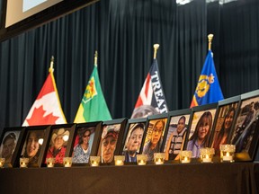 Photos of the victims from the James Smith Cree Nation stabbing rampage are on display with candles on stage where RCMP outlined what happened during the tragedy, at a news conference in Melfort, Sask. on Thursday, April 27, 2023.