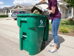 A Saskatoon city hall official demonstrates using a green cart at her parents' home in Saskatoon in June of 2019.