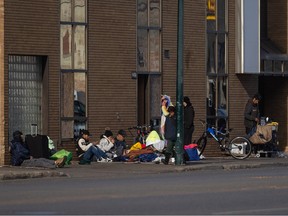 People gather outside a shelter operated by the Saskatoon Tribal Council on First Avenue North opened in December 2021 under provisions of the city's zoning bylaw allowing temporary shelter facilities to operate for up to 18 months in emergency situations. The facility later transitioned to a permanent site in Fairhaven, where it became subject to the same zoning as any special care home.