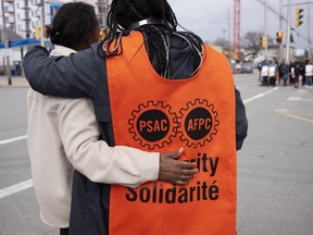 PSAC workers and supporters walk a picket line in Halifax on Wednesday, April 19, 2023. Federal departments and agencies have released a list of services that may be disrupted now that workers are on strike.