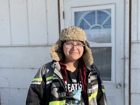 Eleven-year-old Karl Halkett stands in front of Kokum's Cabin in La Ronge, Sask. He says the community's new trans social club made him feel seen and accepted as his true self.