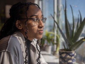 Belan Tsagaye, 19, who has written and published a book of poetry inspired by her lived experiences and time as a mental health advocate, sits for a portrait at Utopia Cafe on Friday, March 31, 2023 in Regina.
