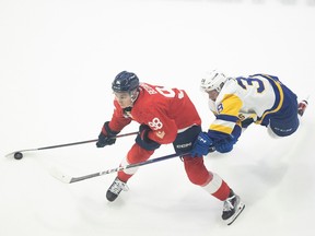 -Regina Pats forward Connor Bedard fights for control of the puck against Saskatoon Blades forward Trevor Wong during game 4 of WHL playoff action at the Brandt Centre on Wednesday, April 5, 2023 in Regina. KAYLE NEIS / Regina Leader-Post