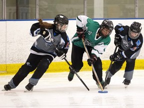 U16AA Quebec Cyclones Noemie Larochelle, left, and Victoria Bolduc, right try to get the ring away from Team Saskatchewan Hanna Bourque during the Canadian Ringette Championships at the Co-operators Centre on Monday, April 10, 2023 in Regina.