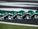 Helmets of the Saskatchewan Roughriders are lined up on the turf during training camp in Saskatoon.