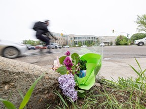 Flowers are placed at the intersection of Wiggins and College Ave. where a 33-year-old cyclist was fatally struck by a cement truck. Photo taken in Saskatoon, Sask. on Thursday, May 25, 2023.