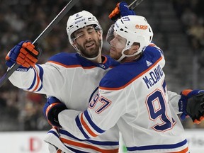 Edmonton Oilers centre Connor McDavid, right, embraces Evan Bouchard (2) after the defenceman scored against the Vegas Golden Knights during the first period of Game 2 of an NHL hockey Stanley Cup second-round playoff series in Las Vegas, Saturday, May 6, 2023. Bouchard, 23, from Oakville, Ont., leads all NHL players in power-play points (12) with three goals and nine assists in eight games.