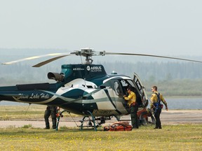 A forestry helicopter like this one, shown in action in 2019 near Slave Lake, was used to rescue a stranded man near Fox Creek.
