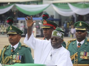 Nigeria's new President Bola Ahmed Tinubu, inspects honour guards after taking an oath of office at a ceremony in Abuja Nigeria, Monday May 29, 2023. A year after arguing Nigeria's ruling party is responsible for terrorist acts, the Trudeau government has sent a cabinet minister to celebrate its presidential visit