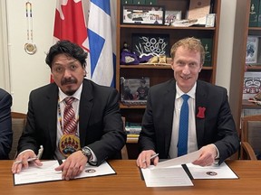 Chief Darcy Bear of Whitecap Dakota Nation (left) and Minister of Crown-Indigenous Relations Marc Miller (right) sign a self-government treaty in Ottawa on May 2, 2023.