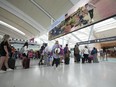 The federal government is announcing a revamp of its trusted-traveller program to help clear clogged airports as the summer travel season kicks off. People line up before entering the security at Pearson International Airport in Toronto on Friday, August 5, 2022.