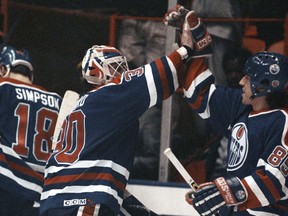 Edmonton Oilers' goalie Bill Ranford, centre and Petr Klima (85), right, celebrate their overtime win to sweep the NHL playoff series against the Los Angeles Kings at the Forum in Inglewood, Calif., Tuesday, April 25, 1990. Klima, whose triple-overtime goal against Boston in Game 1 of the 1990 NHL final ended the longest game in Stanley Cup final history, has died at 58.