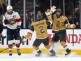 Las Vegas Golden Knights right wing Mark Stone, right, celebrates with defenceman Zach Whitecloud, centre, after scoring as Florida Panthers centre Aleksander Barkov skates away during the first period in Game 5 of the NHL hockey Stanley Cup Finals Tuesday, June 13, 2023, in Las Vegas. The Sioux Valley Dakota Nation in Manitoba is celebrating one of its own after Whitecloud and the Golden Knights won the Stanley Cup.