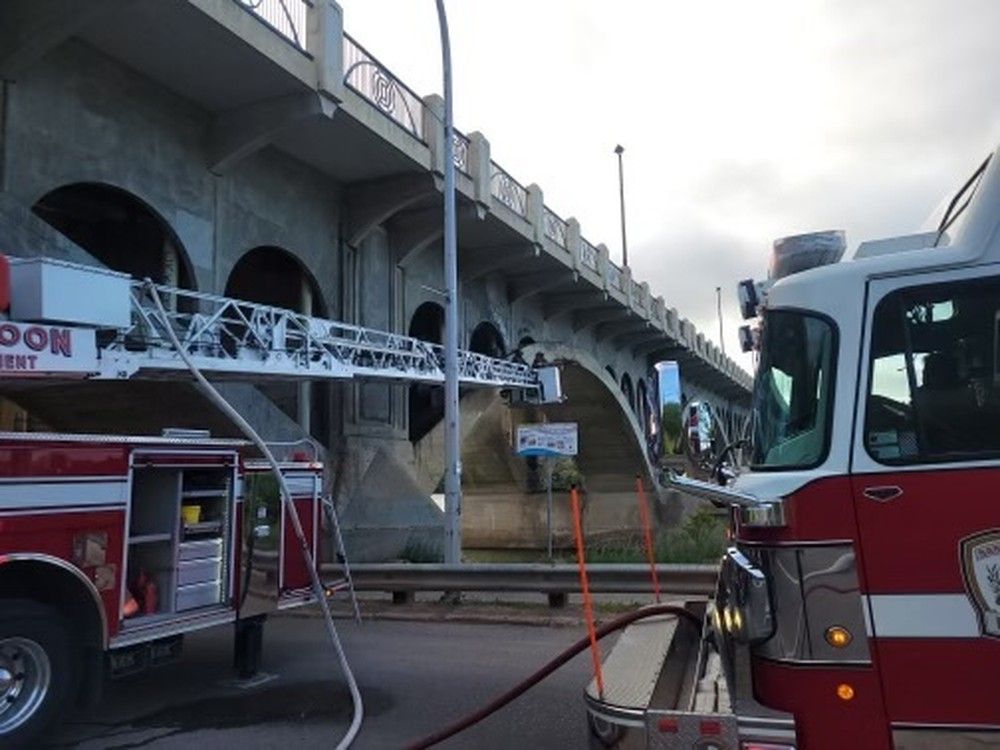 Saskatoon Fire Department crews on scene to battle a fire at an abandoned encampment under the University Bridge on June 21, 2023. Photos provided by the Saskatoon Fire Department.
