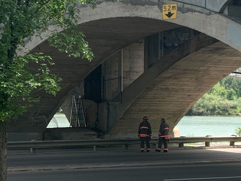 University Bridge was closed while Saskatoon firefighters put out a fire that started within an abandoned encampment under the bridge on June 21, 2022. (Thia James/Saskatoon StarPhoenix)
