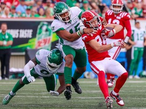 Calgary Stampeders wide receiver Cole Tucker is tackled by Saskatchewan Roughriders defensive lineman Pete Robertson during CFL action against at McMahon Stadium on Saturday, June 24, 2023.