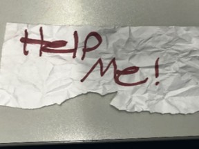 In this undated photo released by the U.S Department of Justice is a "Help Me!" sign used by a 13-year-old girl kidnapped in Texas. The girl was rescued in Southern California on July 9, 2023, when passersby saw her hold up the sign in a parked car, police said. The rescue occurred in Long Beach when officers responded to a trouble call and found the "visibly emotional and distressed girl," police said in a press release Thursday, July 20. (U.S. Department of Justice via AP)