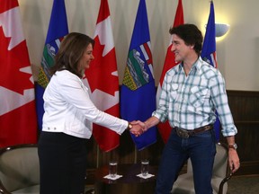 Premier Danielle Smith and Prime Minister Justin Trudeau shake hands in Calgary on Friday, July 7, 2023.