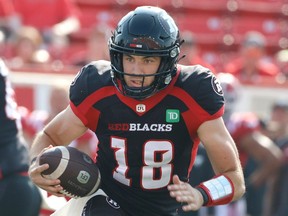 Ottawa Redblacks quarterback Dustin Crum runs the ball during first half CFL football action against the Calgary Stampeders in Calgary on Sunday, July 23, 2023.