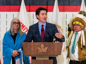 Prime Minister Justin Trudeau, middle, speaks to members of media, as Minister of indigenous Services Patty Hajdu, left, and James Smith Cree Nation Chief Wally Burns look on, at James Smith Cree Nation, Sask., Monday, Nov. 28, 2022.