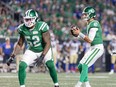 Saskatchewan Roughriders quarterback Jake Dolegala (9) and left tackle Eric Lofton (52) during the Labour Day Classic CFL football game at Mosaic Stadium in Regina, Saskatchewan on Sept. 5, 2023.