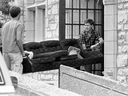 A photo of two students carrying a couch into residence during moving-in day at the University of Saskatchewan, as students arrive for the fall semester, from Sept. 7, 1984.
