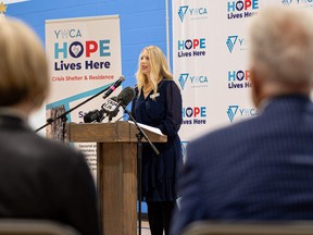 YWCA CEO Cara Bahr gives a speech during a major funding announcement to add more emergency housing units to the YWCA building.
