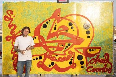 Mural artist Chad Coombs stands for a photo at the Urban Canvas Street Party in the Midtown parking lot.