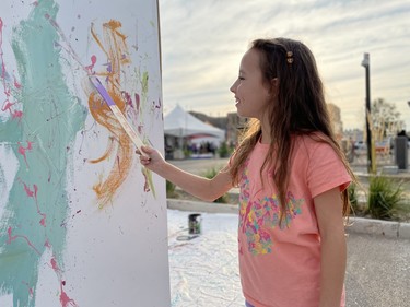 Seven-year-old Martina Russell participates in a collaborative mural at the Urban Canvas Street Party.