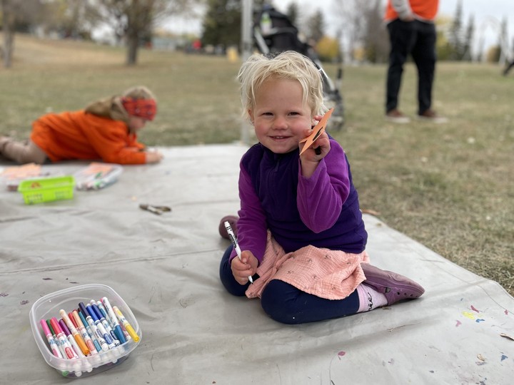  Three-year-old Pippin Neufeld works on an orange shirt craft after the Rock Your Roots Walk for Reconciliation.