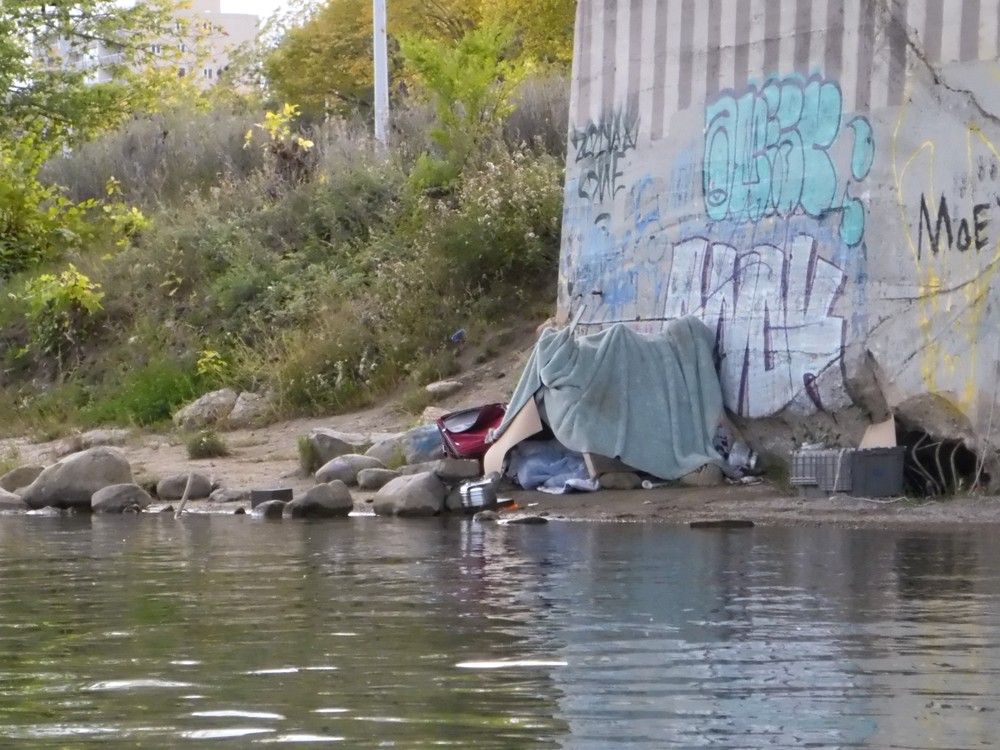 A makeshift tent is seen under the University Bridge at the edge of the South Saskatchewan River in Saskatoon, Sask., in this photo taken on Tuesday, Sept. 12, 2023. (Phil Tank/Saskatoon StarPhoenix)