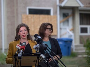 NDP housing critic Meara Conway speaks at a podium beside Saskatchewan NDP Leader Carla Beck in front of a Saskatchewan Housing Corporation unit on Rae street to discuss the current housing issue on Tuesday, July 25, 2023 in Regina. KAYLE NEIS / Regina Leader-Post