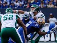 Saskatchewan Roughriders quarterback Jake Dolegala (9) gets hit by Winnipeg Blue Bombers' Jackson Jeffcoat (94) during the first half of CFL football action in Winnipeg Saturday, September 9, 2023.