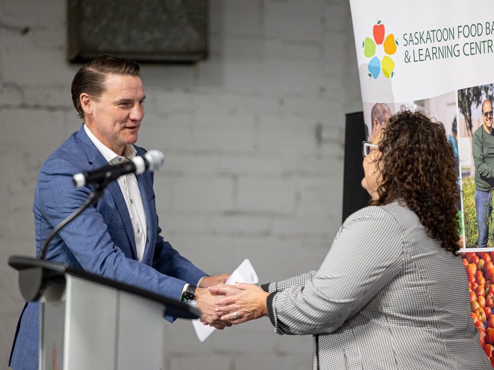Campaign chair Chris Reynolds shakes hands with Laurie O'Connor, executive director at the Saskatoon Food Bank and Learning Centre, during the official launch of its capital campaign to raise $12 million towards the construction of its new location. Photo taken in Saskatoon, Sask. on Thursday, October 5, 2023.