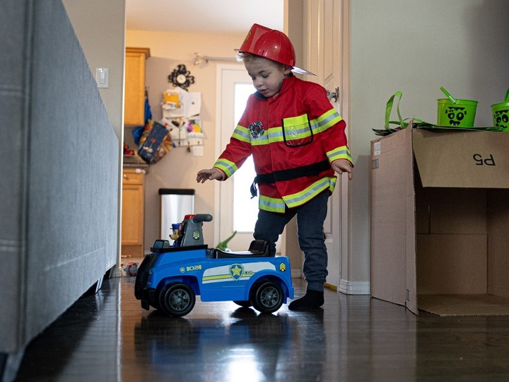  Four-year-old Emmett Doucette is dressed as a firefighter while playing with his cars at his home in Saskatoon. He has Sanfilippo Syndrome, an extremely rare, terminal condition that causes a gradual loss of cognitive and motor function.