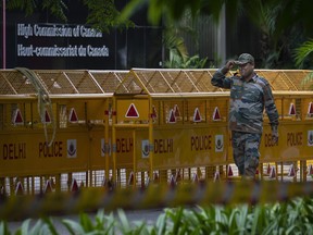 An Indian paramilitary soldier stands guard next to a police barricade outside the Canadian High Commission in New Delhi, India, Tuesday, Sept. 19, 2023. India is defending its diplomatic actions a day after Ottawa announced it had pulled most of its envoys from the country over what it called a precedent-setting diplomatic threat.