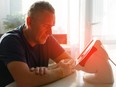 Man using infrared light therapy.