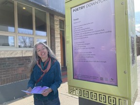 Danica Lorer reads her poem, Treats, during a walking tour of the Poetry Downtown project on October 14, 2023.
