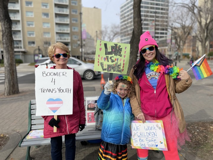  From left, Kerry Giesbrecht, Sloane Eaglesham and Hayley Eaglesham attend a rally for trans rights in Saskatoon on Oct. 21.