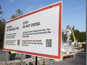 A newly released memo shows federal officials quietly warned last spring that expansion of a bilateral refugee pact to the entire Canada-U.S. border would likely fuel smuggling networks and encourage people to seek more dangerous, remote crossing routes. Workers demolish the temporary installation for refugee claimants at Roxham Road in St. Bernard-de-Lacolle, Que., Monday, Sept. 25, 2023.