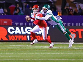 Calgary Stampeders quarterback Jake Maier is tackled by Saskatchewan Roughriders defensive lineman Pete Robertson during CFL action against the at McMahon Stadium in Calgary on Friday, October 13, 2023.
