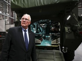 Minister of National Defence Bill Blair stands at the rear of a new ambulance variant to the armoured combat support vehicle fleet at Garrison Petawawa, Ont., on Thursday, Oct. 19, 2023. Blair is expected to face further questions today about the evidence Canada has showing a rocket blast at a hospital in Gaza City originated within the Gaza Strip