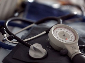 A photo illustration shows a stethoscope and blood-pressure machine of a general practitioner displayed in a doctor's office.