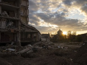 The sun sets over a destroyed building in Izyum, Ukraine, Tuesday, Oct. 24, 2023.