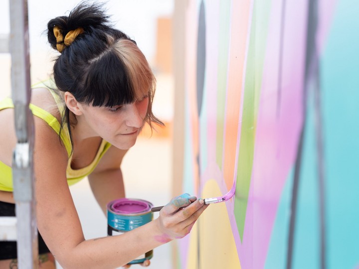  Dakota Ray Hebert paints a mural at the Urban Canvas Street Party in the Midtown parking lot in Saskatoon on Sept. 8, 2023. (Michelle Berg / Saskatoon StarPhoenix)