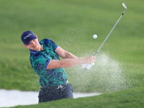 Matt Wallace of England plays his third shot on the 18th hole from a bunker during Day Three of the DP World Tour Championship on the Earth Course at Jumeirah Golf Estates on November 18, 2023 in Dubai, United Arab Emirates.