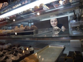 Summer Stopanski stands for a portrait behind a display of baked goods at Sinfully Sweet Cathedral Bakery on Friday, November 17, 2023 in Regina. A strike at the Rogers Sugar refinery in Vancouver has caused prices to rise for local bakers.