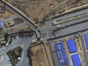 This image provided by Maxar Technologies shows a close view of the Rafah border crossing between Gaza and Egypt, with humanitarian-associated trucks lined up at and near the border, Tuesday, Nov. 7, 2023.